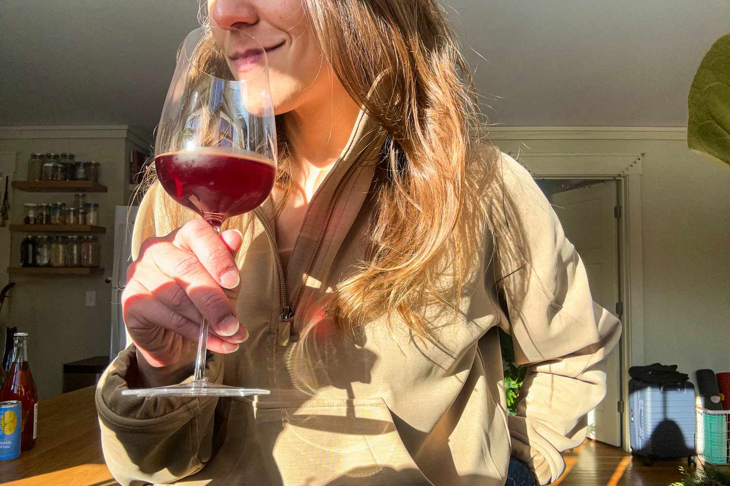 A person smelling a glass of nonalcoholic wine