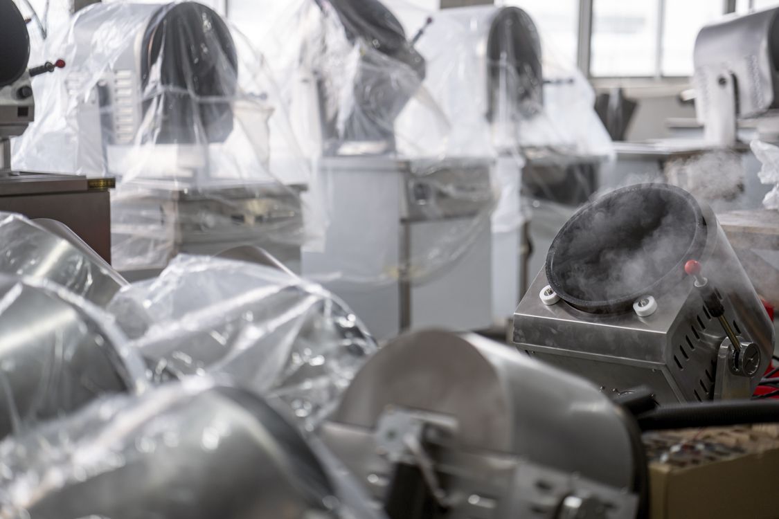 Smoke comes out of an automatic wok in a factory