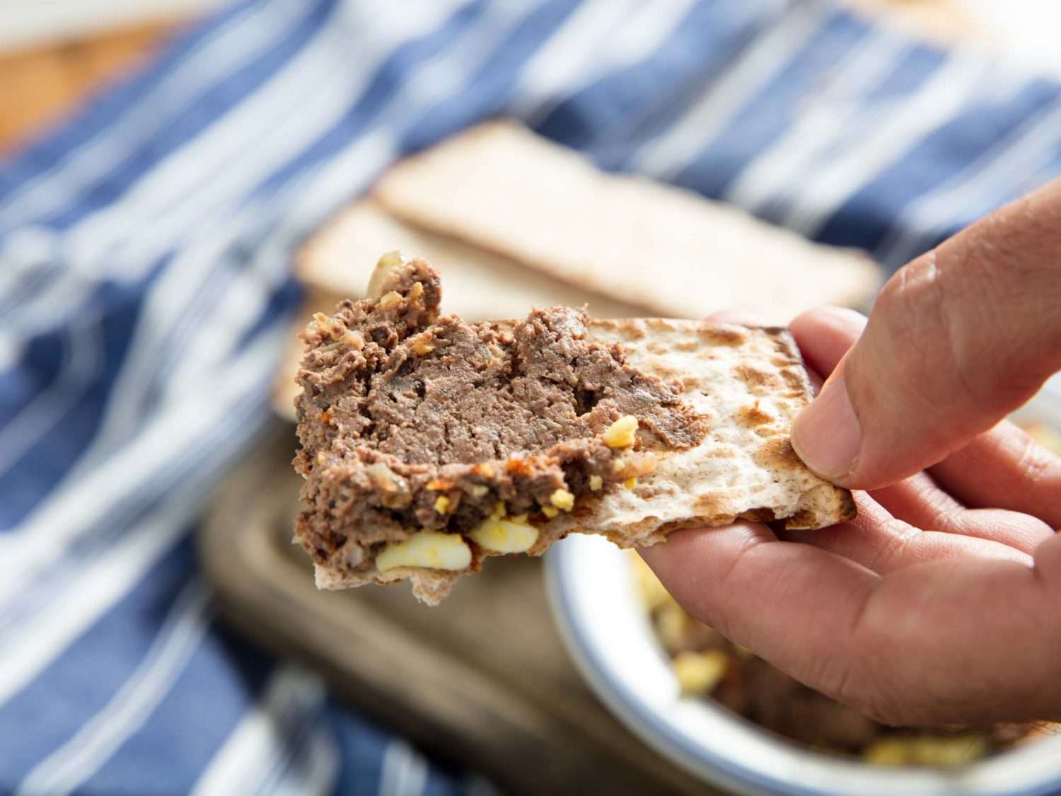 A close-up of chopped liver on a piece of matzo.