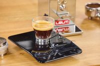 A glass of espresso on an electronic scale made using the Lelit Fred Tempo Burr Grinder
