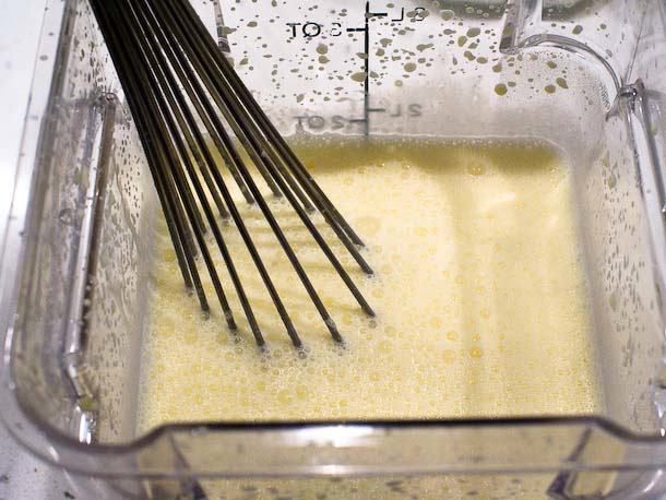 Whisking together ingredients for custard base in a square plastic container.