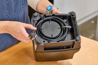 A person holding the cord on the bottom of the Vitamix 5200 Professional-Grade Blender