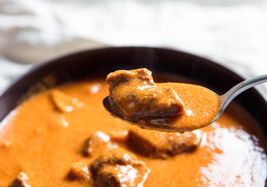 A spoonful lifted from a bowl of rich Ghanaian goat and tripe soup. 