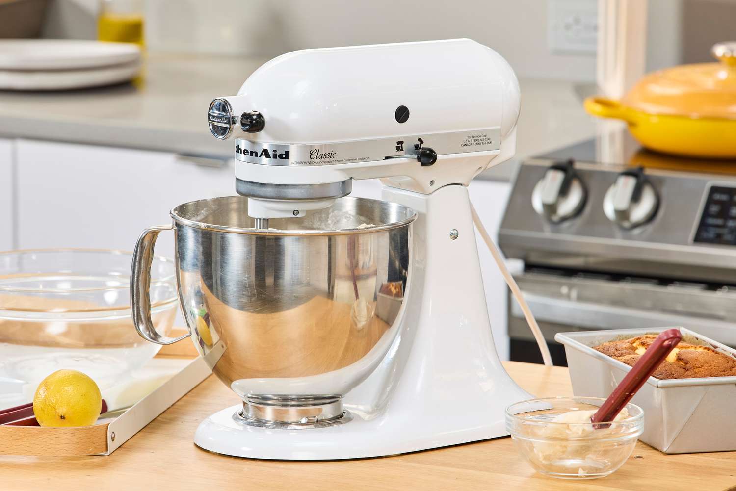 The KitchenAid Classic Plus Series 4.5 Quart Tilt-Head Stand Mixer on a kitchen counter