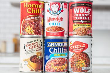 A selection of canned chili brands including Hormel Wendys Wolf Brand Trader Joes Armour and Chili with Beans