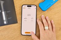 Smartphone showing the Anova Culinary Precision Cooker Pro app interface, with a hand placed nearby on a wooden table