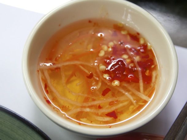 A small white bowl holding Nước chắm