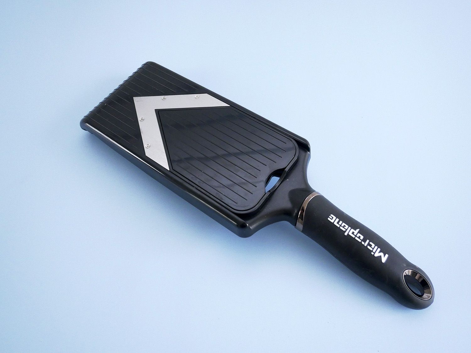 microplane mandoline on pale blue background