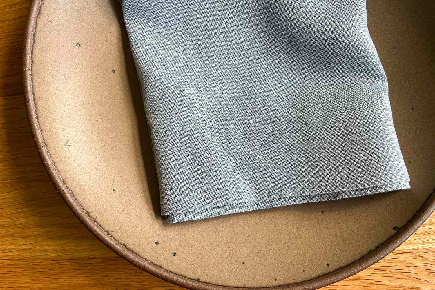 Folded cloth napkin on a ceramic plate