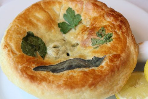 A Coquilles St. Jacques pot pie covered in a puff pastry lid