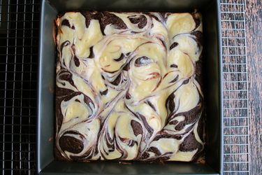 Overhead view of a pan of Cheesecake Swirl Brownies, fresh from the oven.