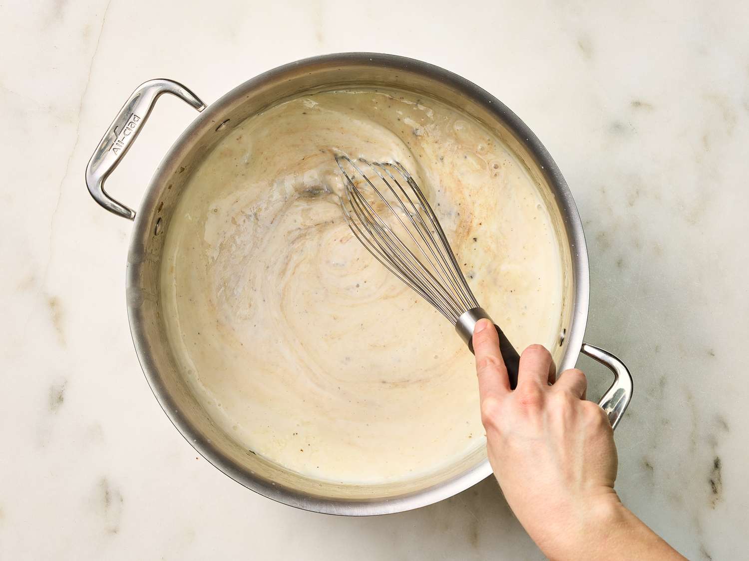 stirring in mustard, boullion and pepper in a pot 