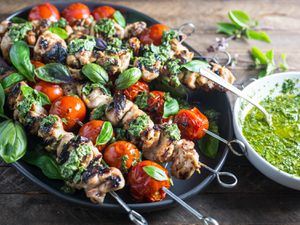 Closeup of Grilled Lemon-Garlic Chicken and Tomato Kebabs With Basil Chimichurri.