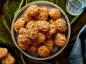 A plate of cookies topped with crumbled nuts