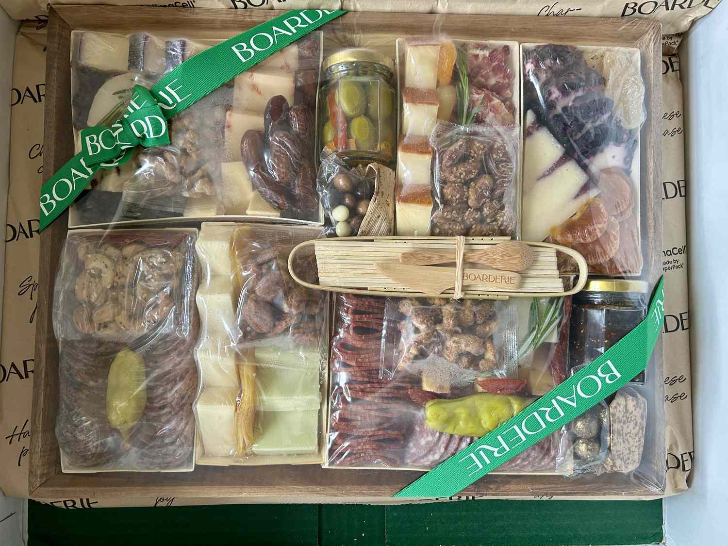 The Boarderie charcuterie board shrink-wrapped in plastic.