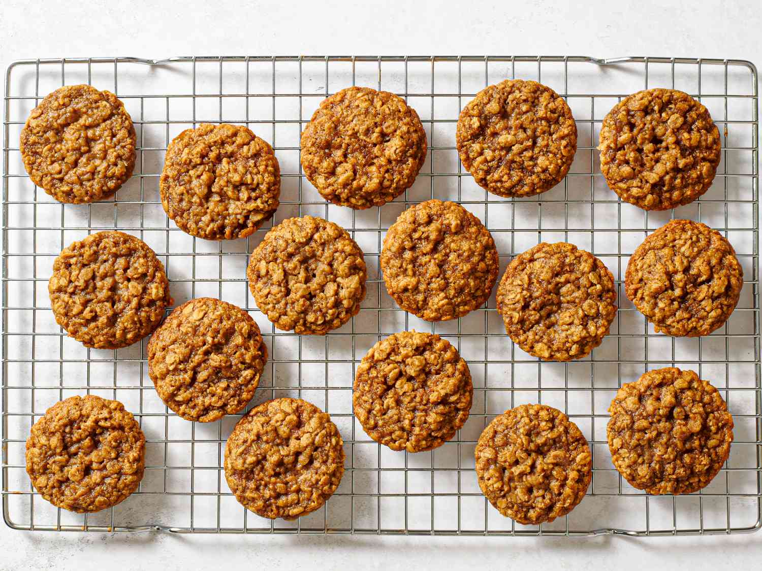 The baked maple brown sugar oatmeal cookies cooling on a wire rack.