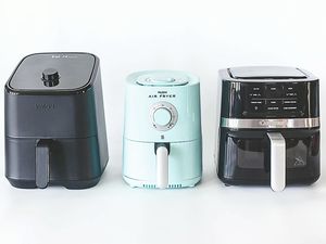 Three air fryers of different brands are displayed