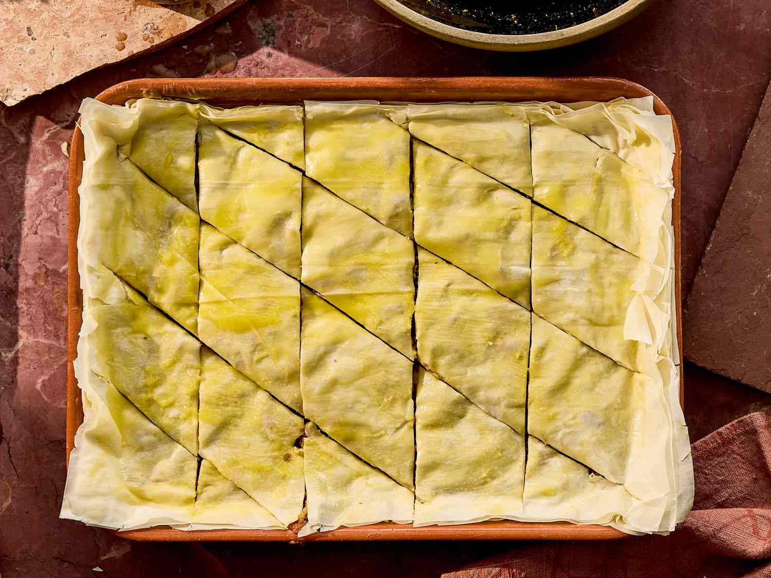 A tray of cut rectangular pieces of carrot cake baklava, before baking