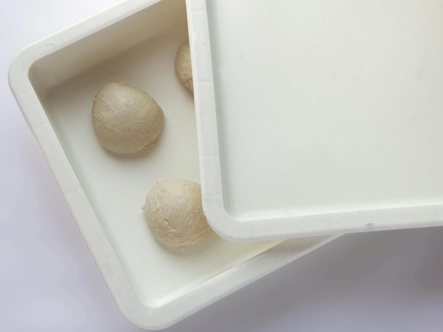 a white rectangular dough proofing container with a lid