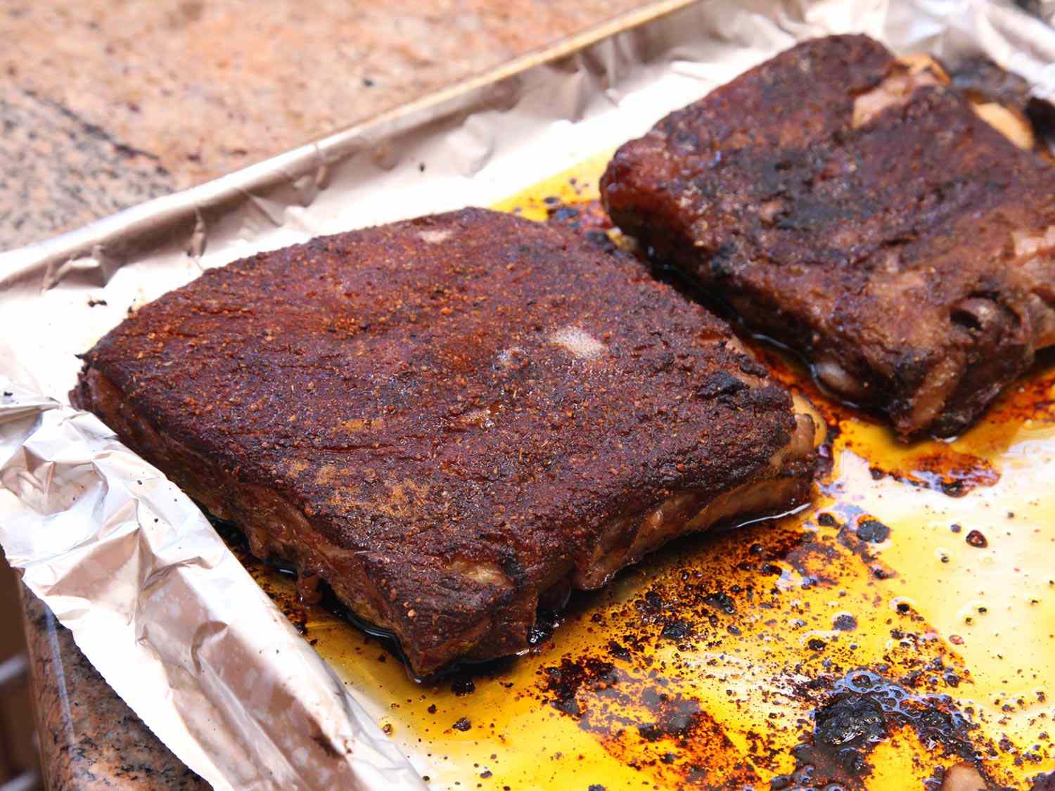 Sous vide pork ribs on a foiled baking sheet and browned in the oven.