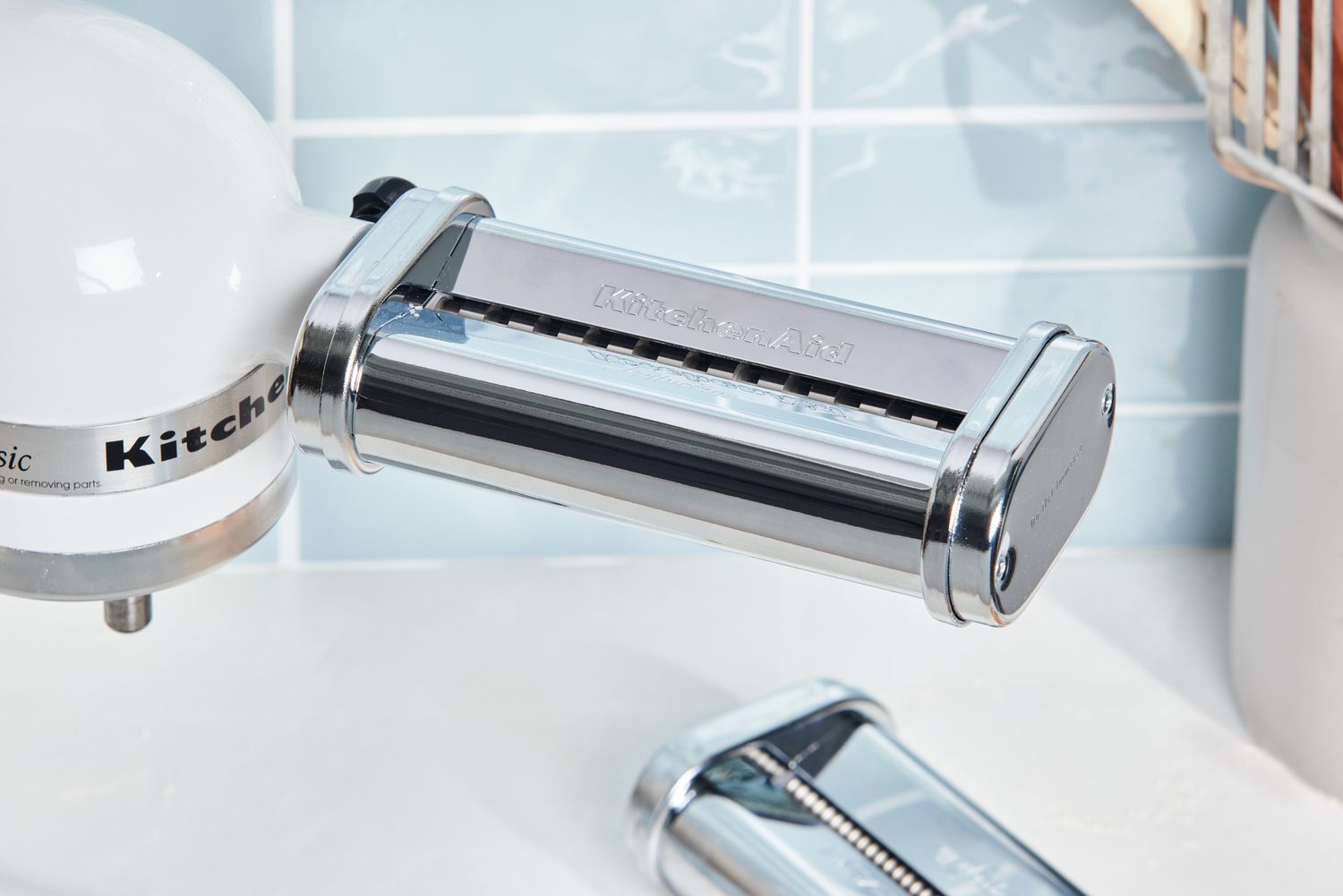 Closeup of KitchenAid cutter attachment secured to front of stand mixer