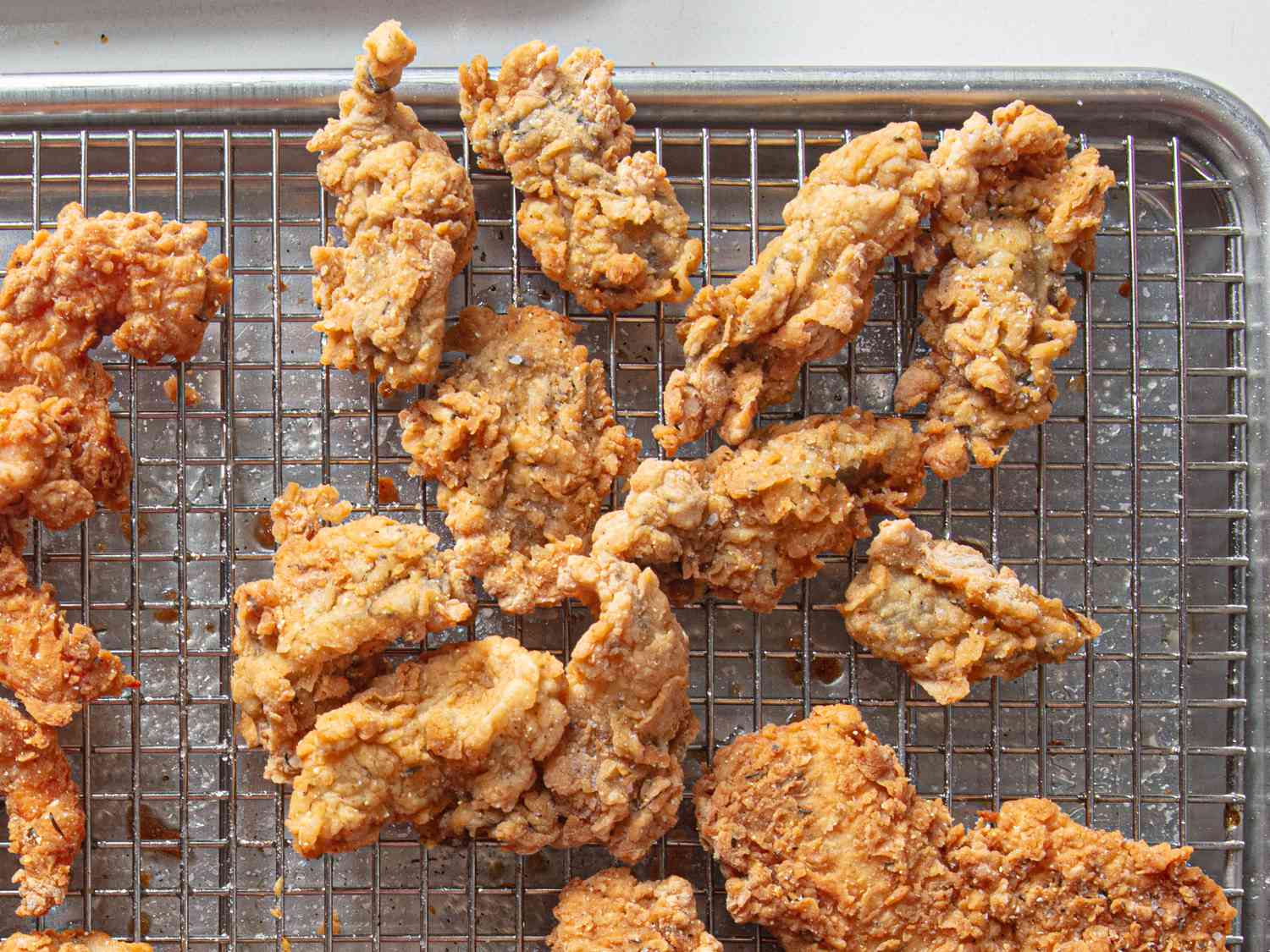 Fried oysters on a wire rakc.