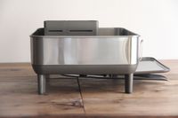 Simplehuman Standard Steel Frame Dish Rack displayed on a wood surface