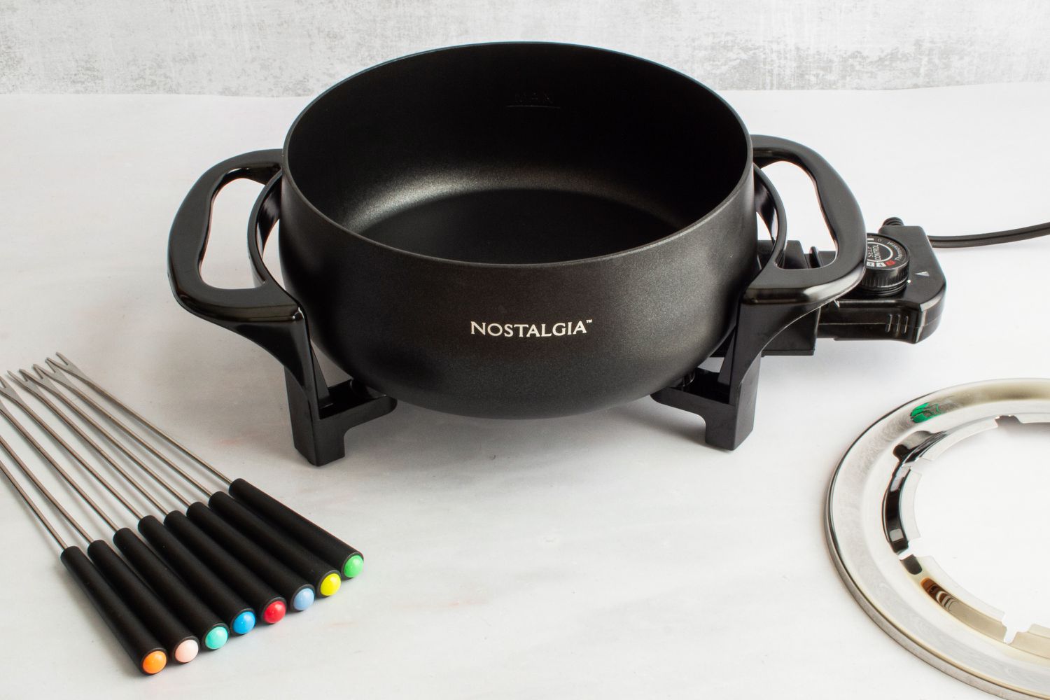 The Nostalgia fondue pot with its forks and fork ring.