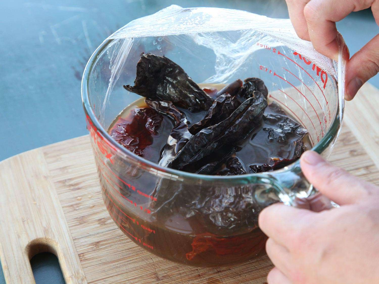 Chiles have been microwaved in a liquid measuring cup with stock.