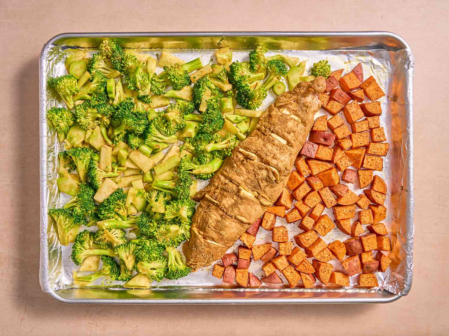 Sheetpan with broccoli added to the side of pork and sweetpotatoes