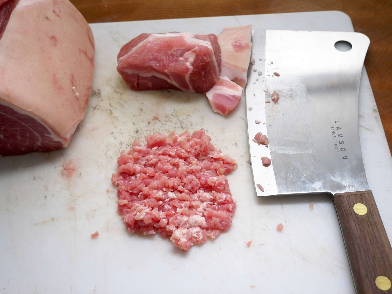 a lamson meat cleaver next to a pile of minced pork