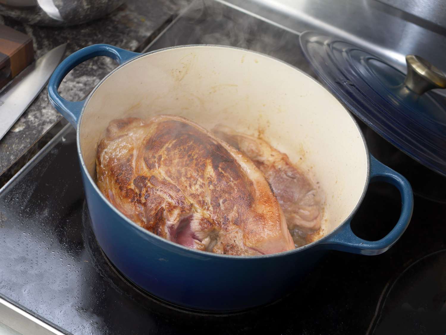 Le creuset dutch oven with a seared pork shoulder inside