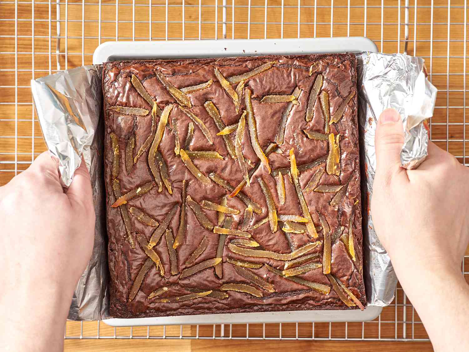 Brownies being lifted from their baking pan.
