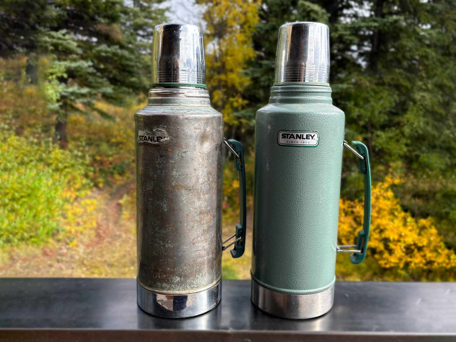 two stanley thermoses with one that's new and one old one