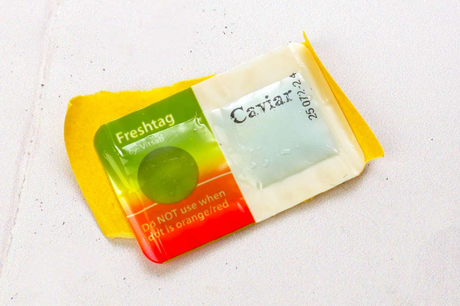 Package labeled Freshtag and Caviar with instructions on dot color