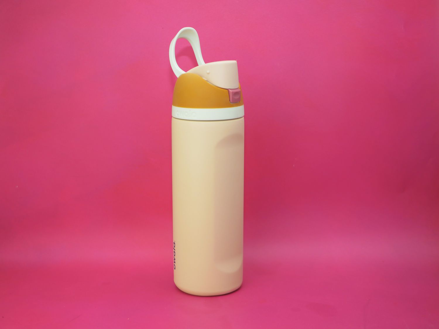 the owala water bottle on a pink surface