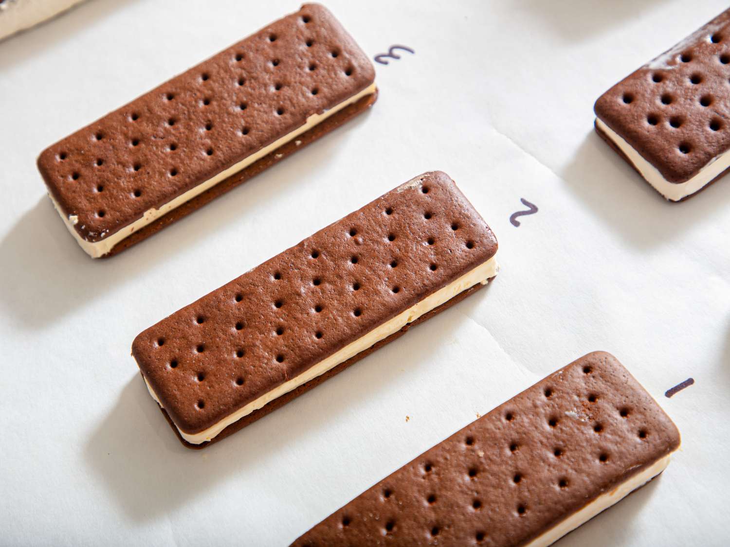 Several ice cream sandwiches arranged on a surface, numbered