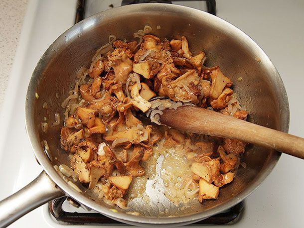 Chanterelles, shallot, and garlic are cooked in a saucepan.