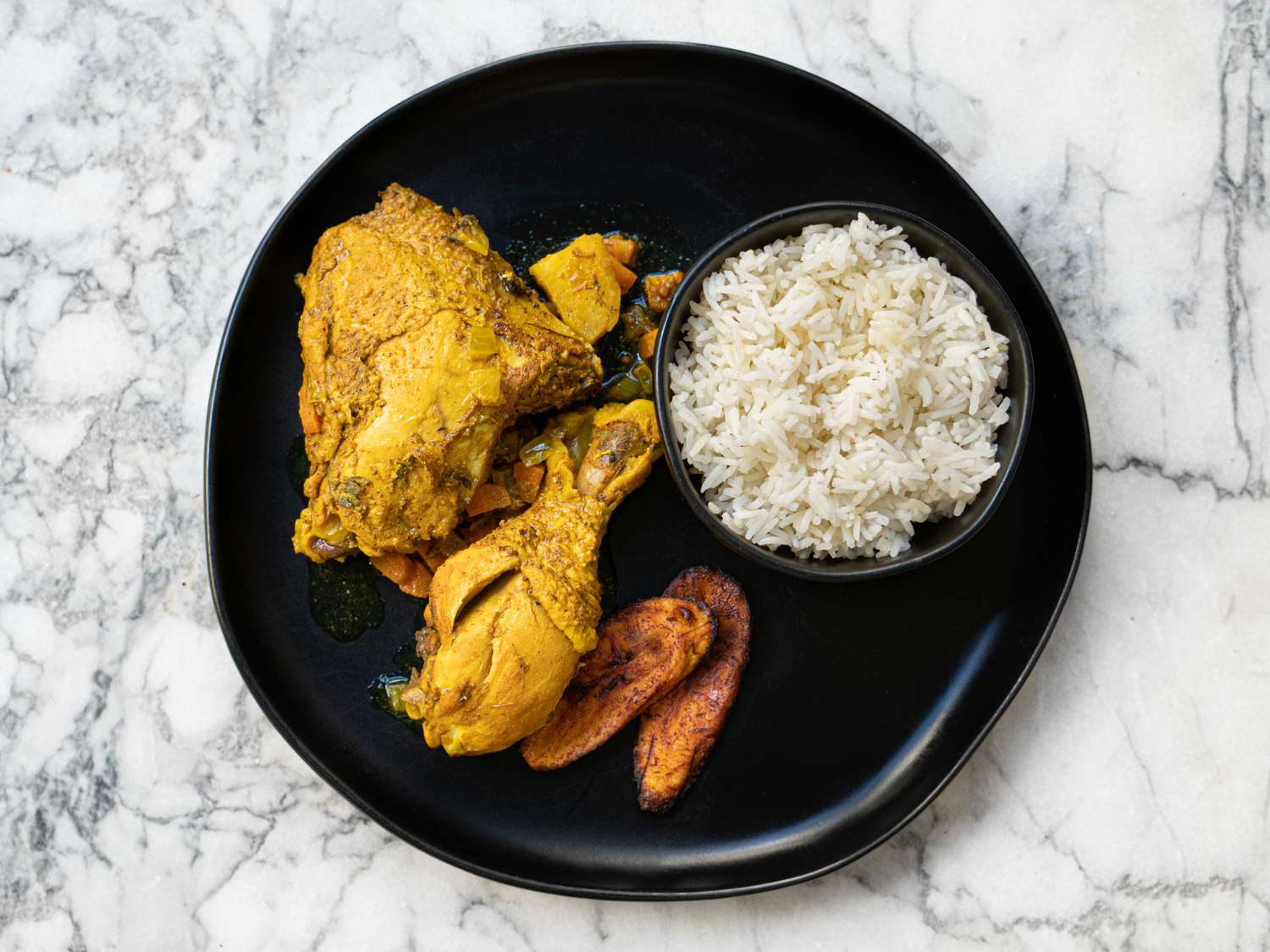 Overhead view of single serving of curry chicken with rice