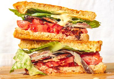 Two halves of the Caesar BLT stacked on top of each other