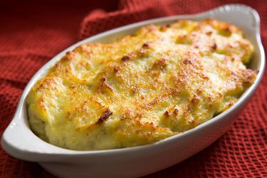 Closeup of a gratin dish of lightly browned brandade, fresh from the oven.