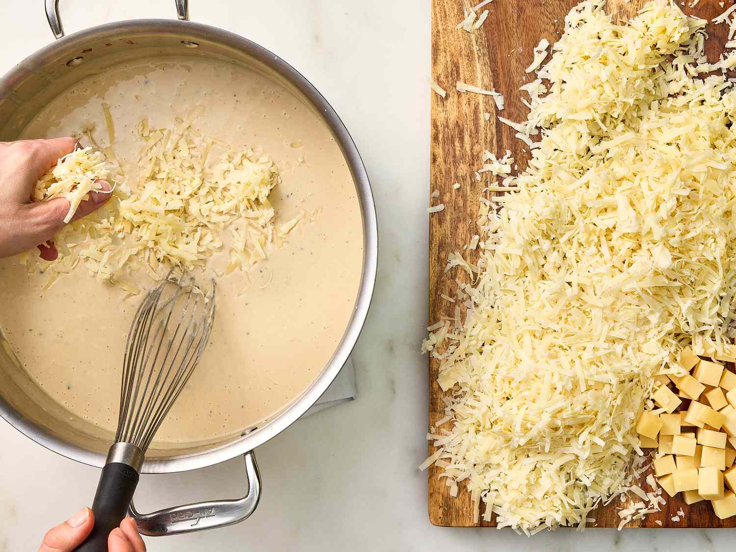 Adding in shredded cheese into the bowl, and shredded cheese on a wooden board the side