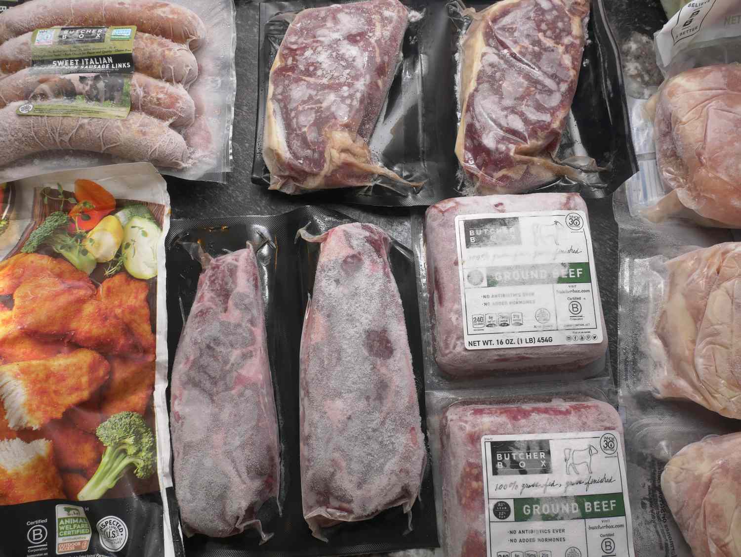 Packages of frozen steaks, ground beef, sausages, and chicken nuggets