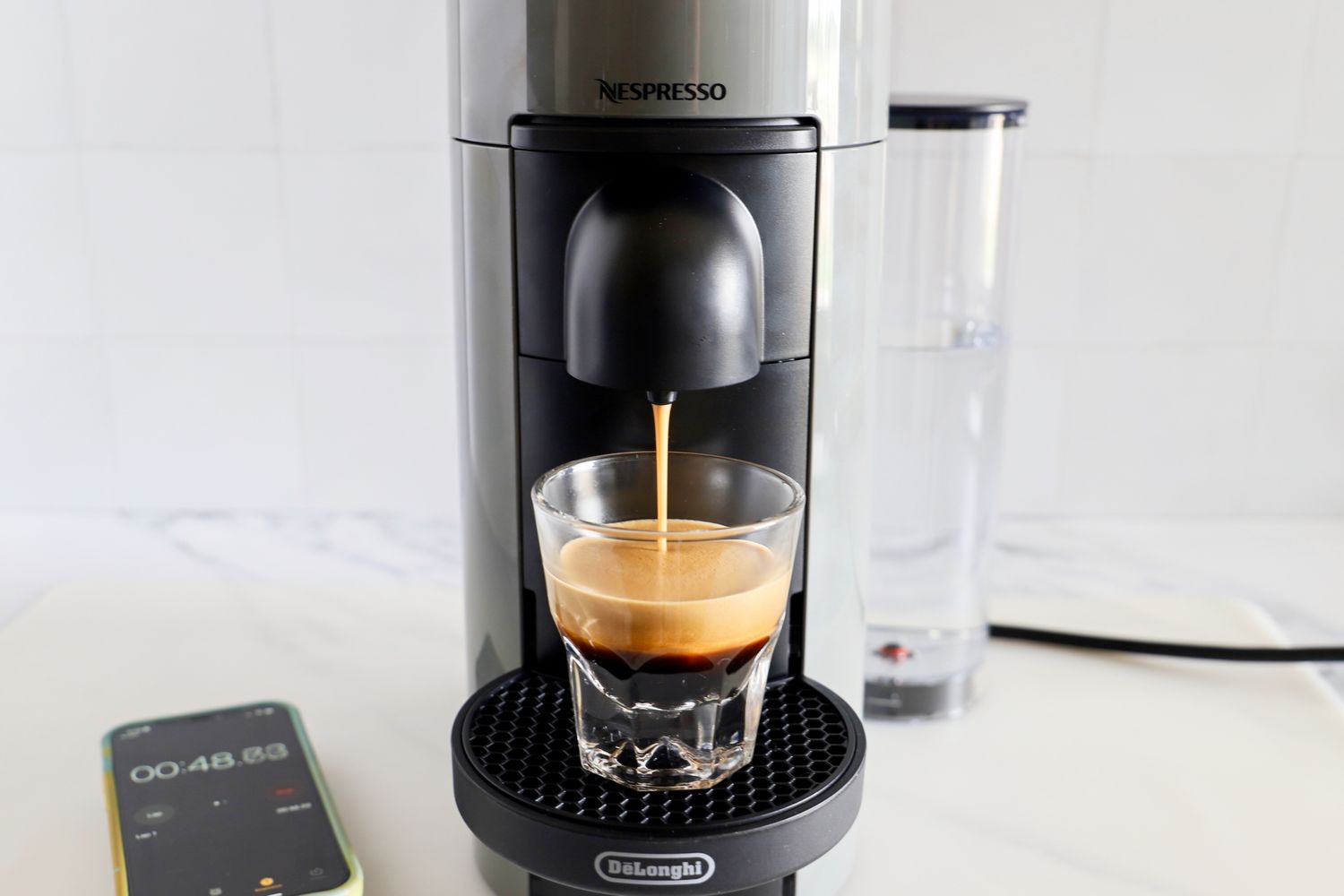 The Nespresso VertuoPlus Coffee and Espresso Machine by De'Longhi dispensing espresso into a cup