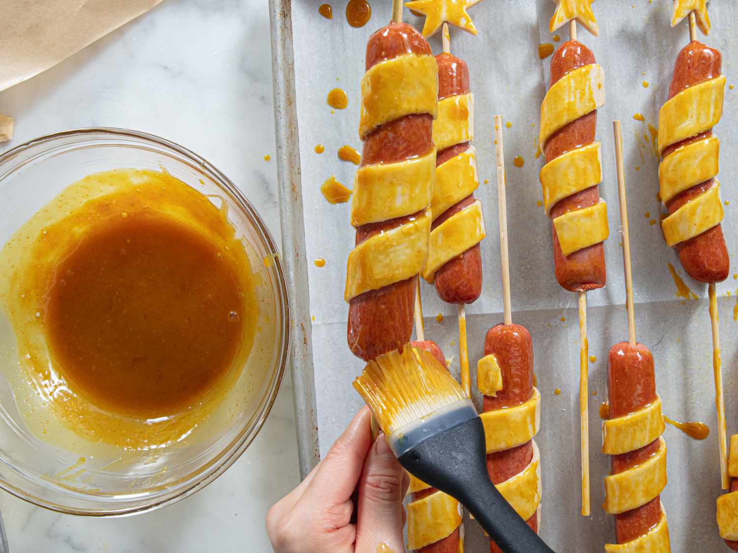 Overhead view of glazing hotdogs