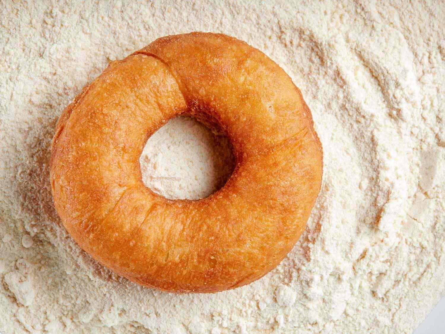 an apple cider donut dipped in apple-sugar