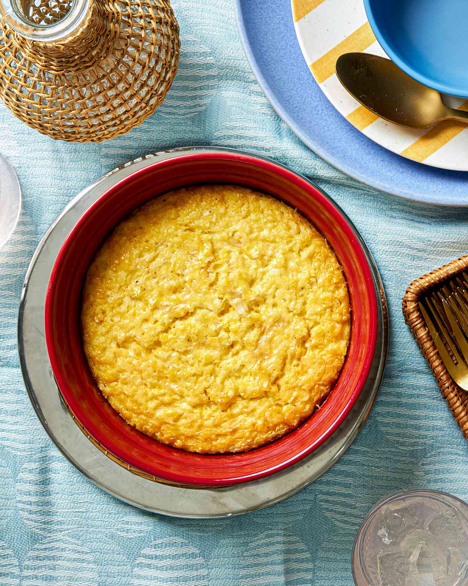 Corn pudding in a red baking dish.