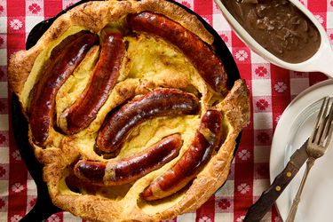 Toad in the Hole served in a skillet with a red checkered tablecloth
