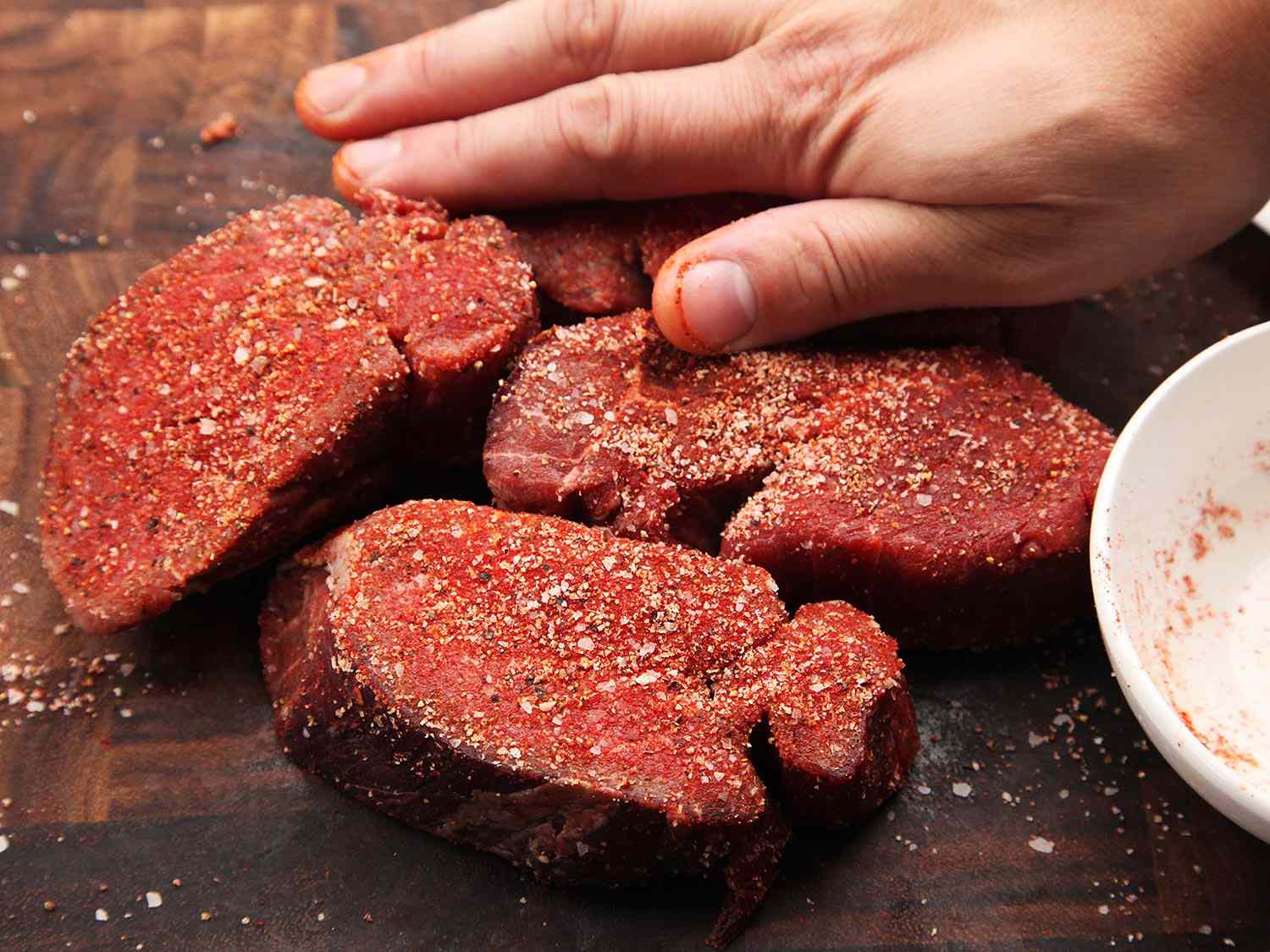 Cuts of beef covered in a meat rub.