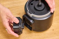 a person removing the battery from a food processor